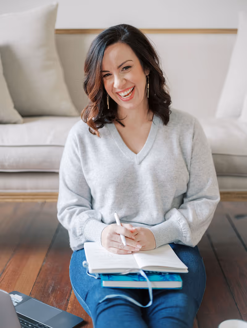A wedding planner working on her marketing strategy at her laptop. Photo credit Bloom and Flourish Studio