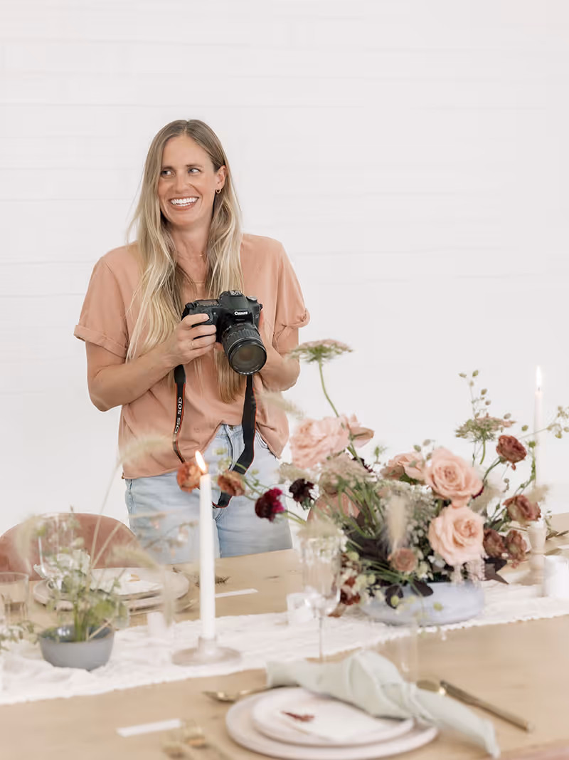A wedding planner working on her marketing strategy at her laptop. Photo credit Bloom and Flourish Studio