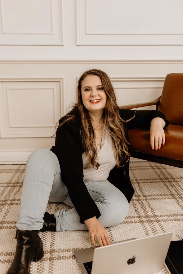 A wedding planner working on her marketing strategy at her laptop. Photo credit Bloom and Flourish Studio
