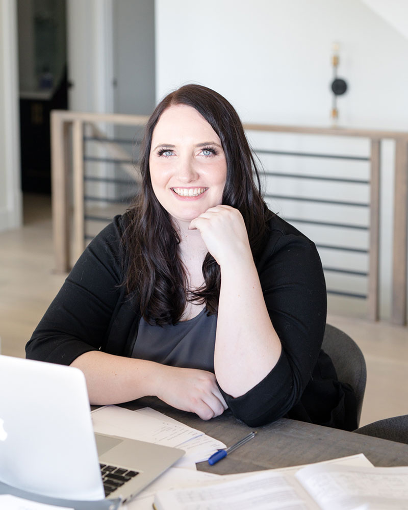 A wedding planner working on her marketing strategy at her laptop. Photo credit Bloom and Flourish Studio