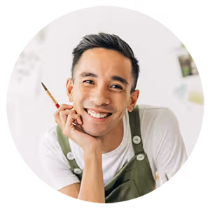 Headshot of a man holding a paintbrush