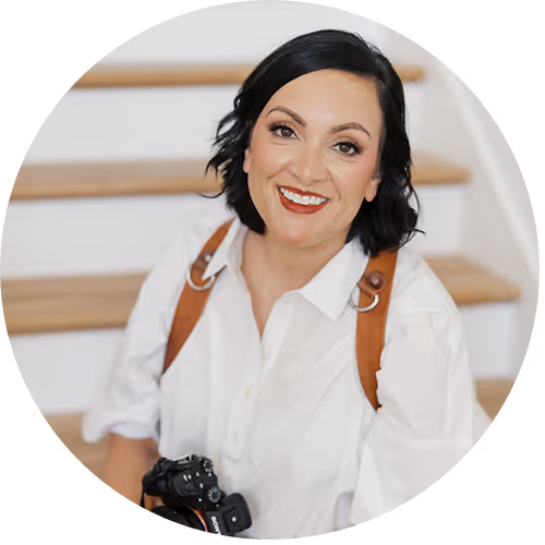 Headshot of a woman holding a professional camera