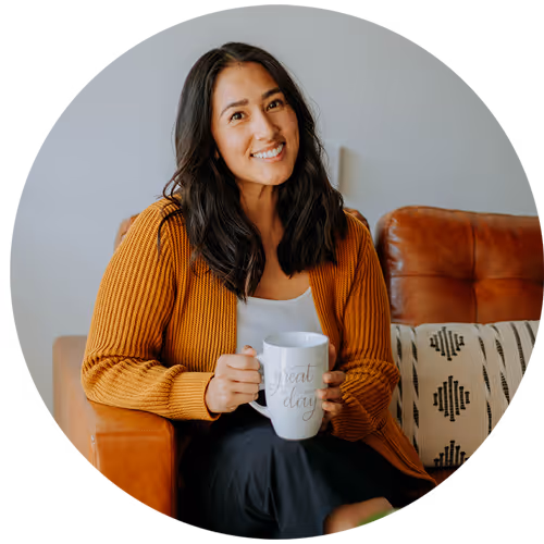 Headshot of a woman sitting holding a coffee mug