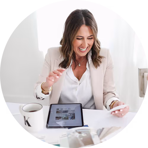 Headshot of a woman sitting at a desk with an ipad