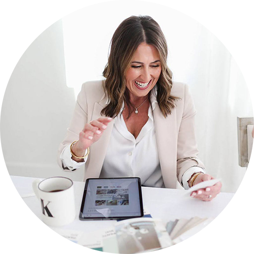 Headshot of a woman sitting at a desk with an ipad