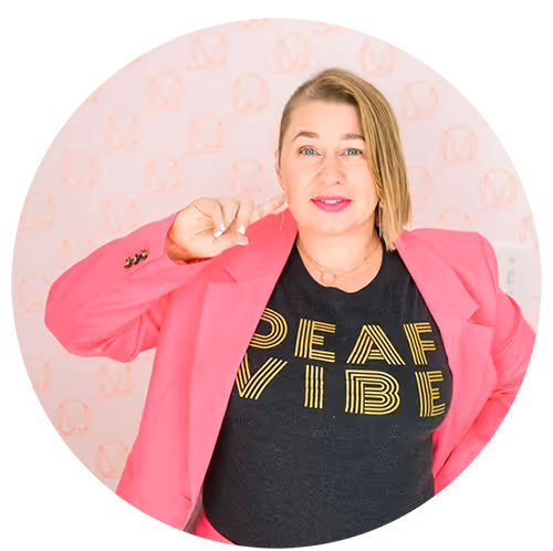 Headshot of a woman in a pink blazer