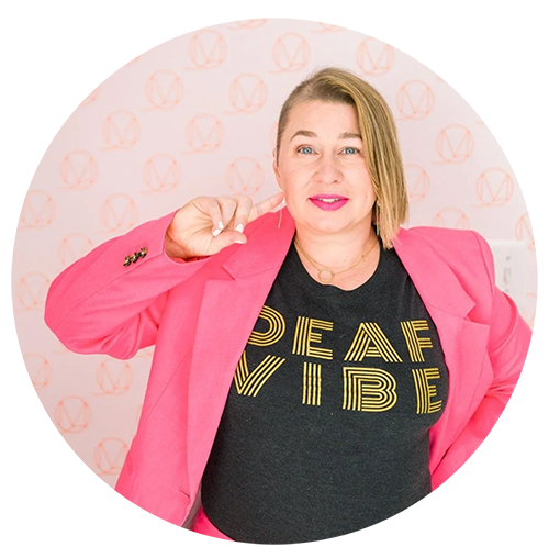 Headshot of a woman in a pink blazer