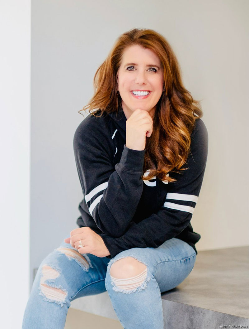 A wedding planner working on her marketing strategy at her laptop. Photo credit Bloom and Flourish Studio