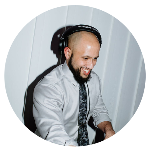 A male wedding DJ with headphones on his head