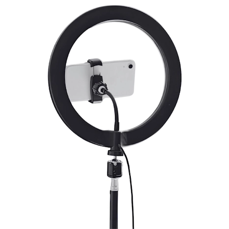 Smartphone mounted on a ring light setup representing influencer content creation.