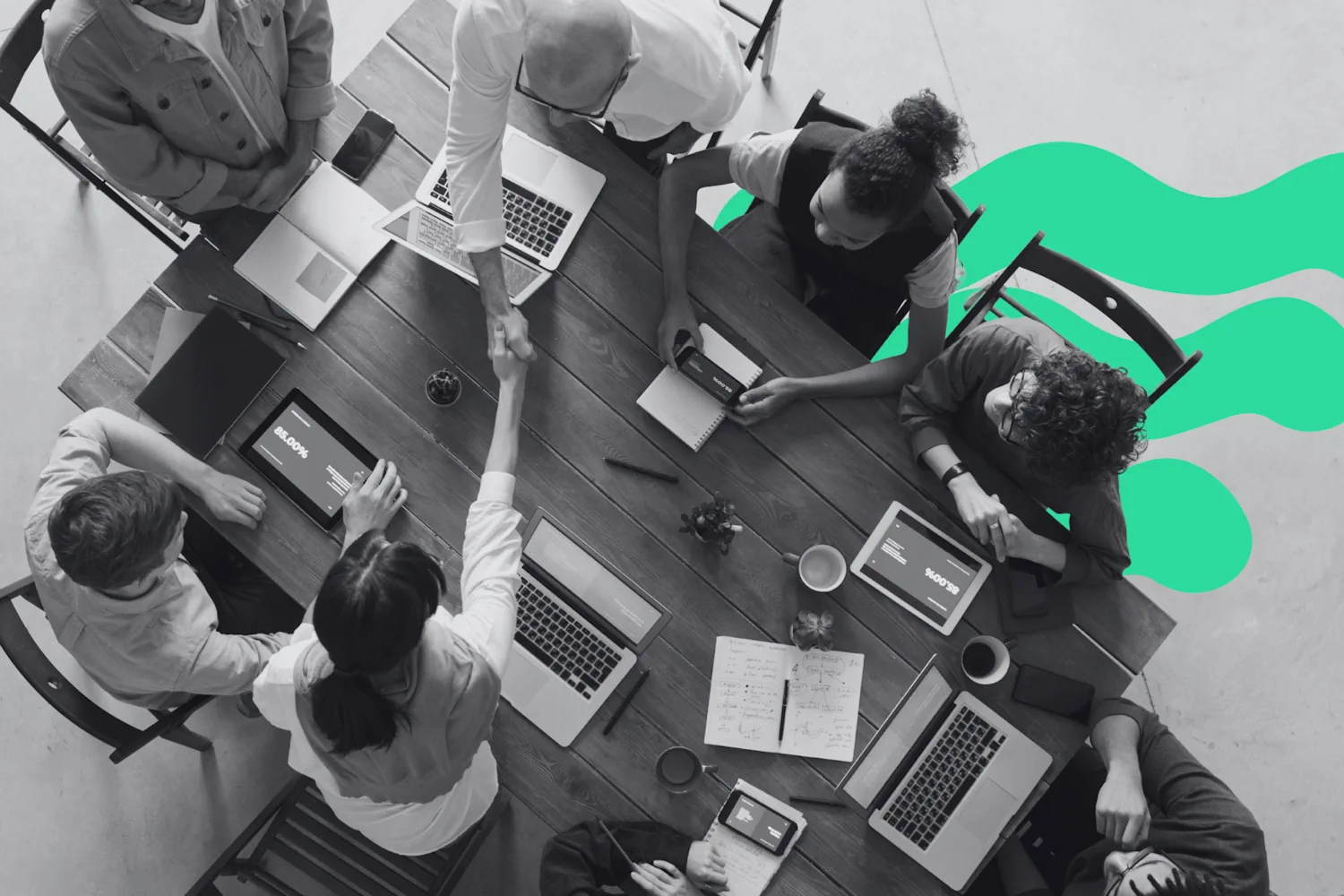 Overhead view of a business team shaking hands in a meeting, representing a strategic PR partnership for an AI workflow platform's US expansion.