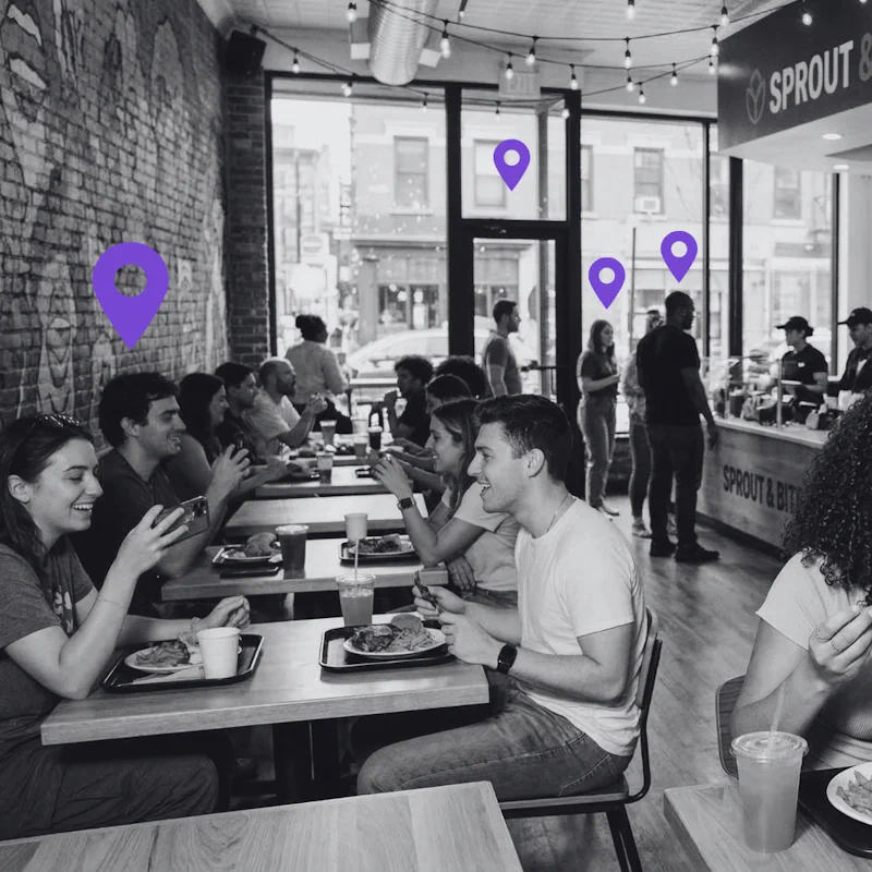 Diners at a crowded restaurant with purple location pins overhead, illustrating the challenge of driving local foot traffic through digital marketing.