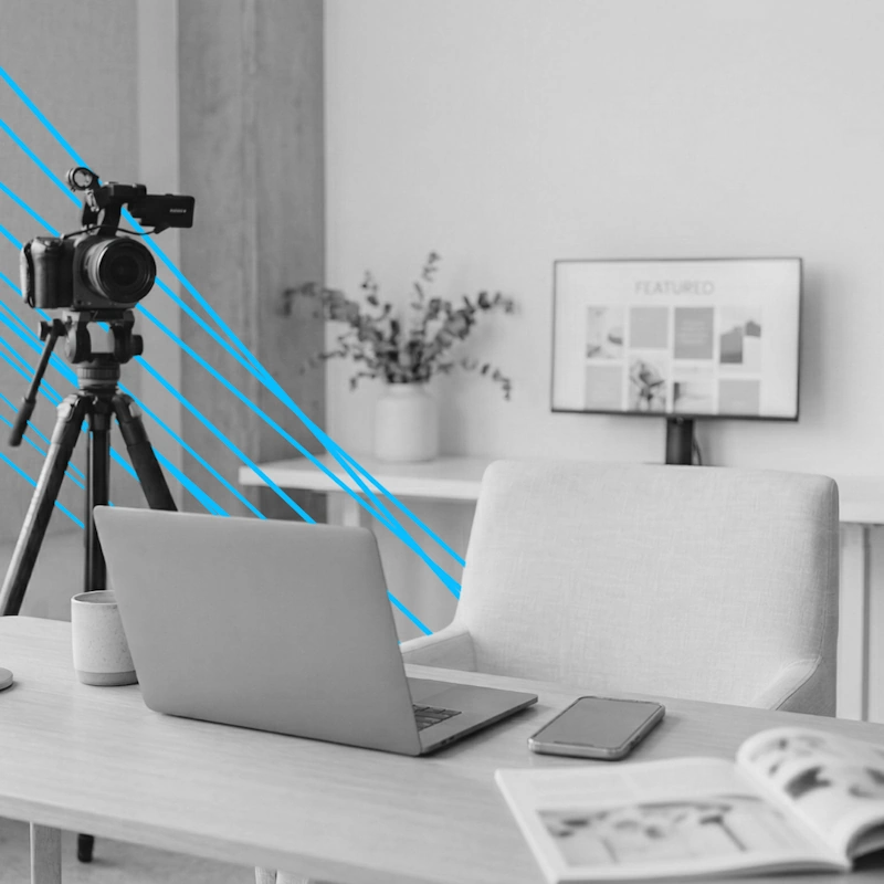 Media interview setup with a camera, laptop, and featured press clippings on a monitor, showcasing the results of an expert skincare PR strategy