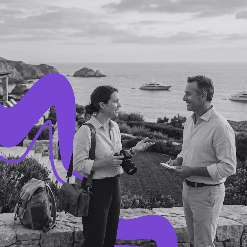 Photographer discussing creative ideas with a client at an oceanfront estate, illustrating tailored PR strategy execution.
