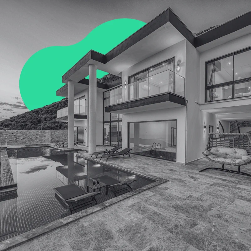 Modern luxury villa with a private swimming pool and patio loungers, representing successful brand positioning for luxury real estate.