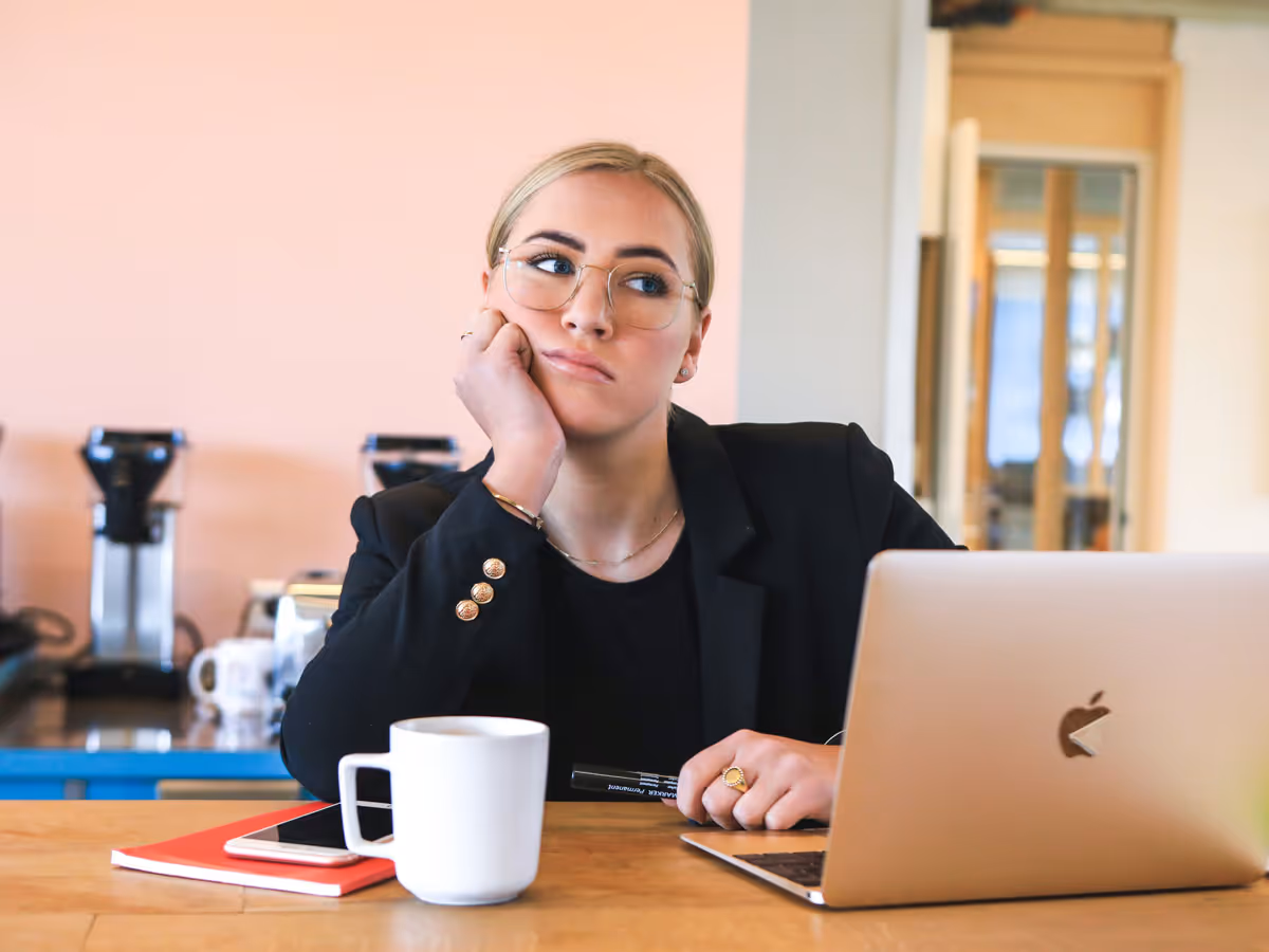 A woman being bored at her laptop