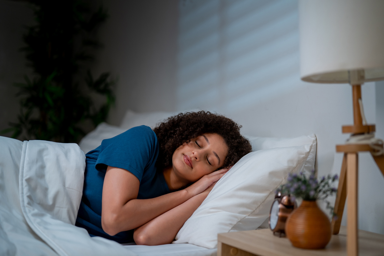 Woman sleeping on side in bed