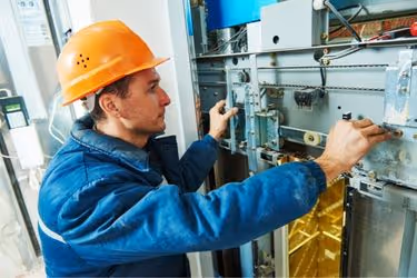 Man doing maintenance on an elevator