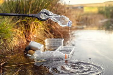 Trash and plastic bottles in the pond