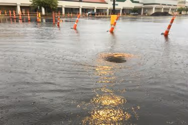 Water draining slow in a flooded parking lot