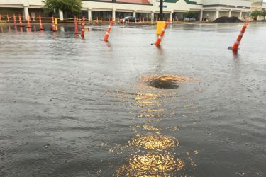 Water draining slow in a flooded parking lot