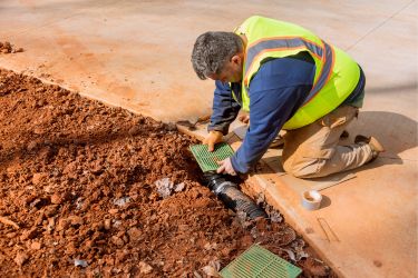 Worker repairing drainage
