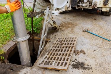 Catch Basin being cleaned with a vacuum
