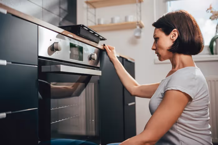 Featured Blog: A woman looking at a dishwasher