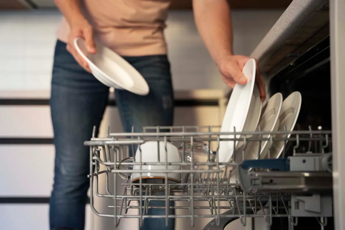 Featured Blog: A woman looking at a dishwasher