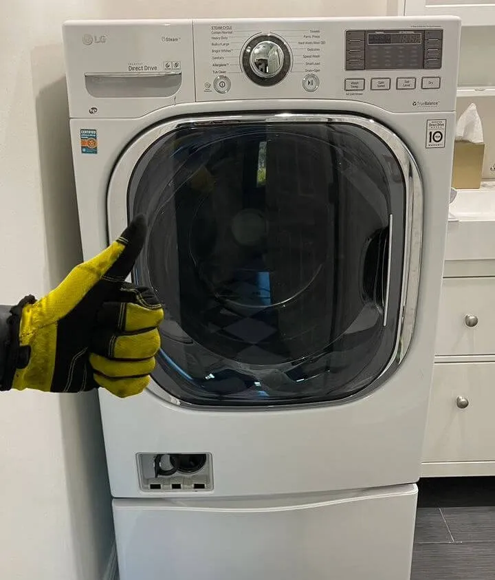 Dryer repair completed – technician approval gesture.