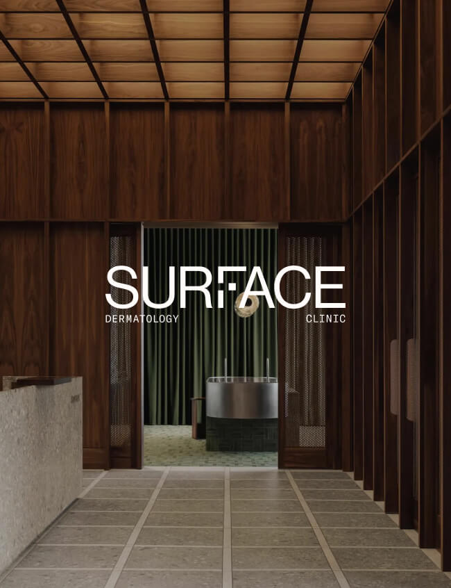 SURFACE dermatology clinic logo overlaying an image of the clinic interior