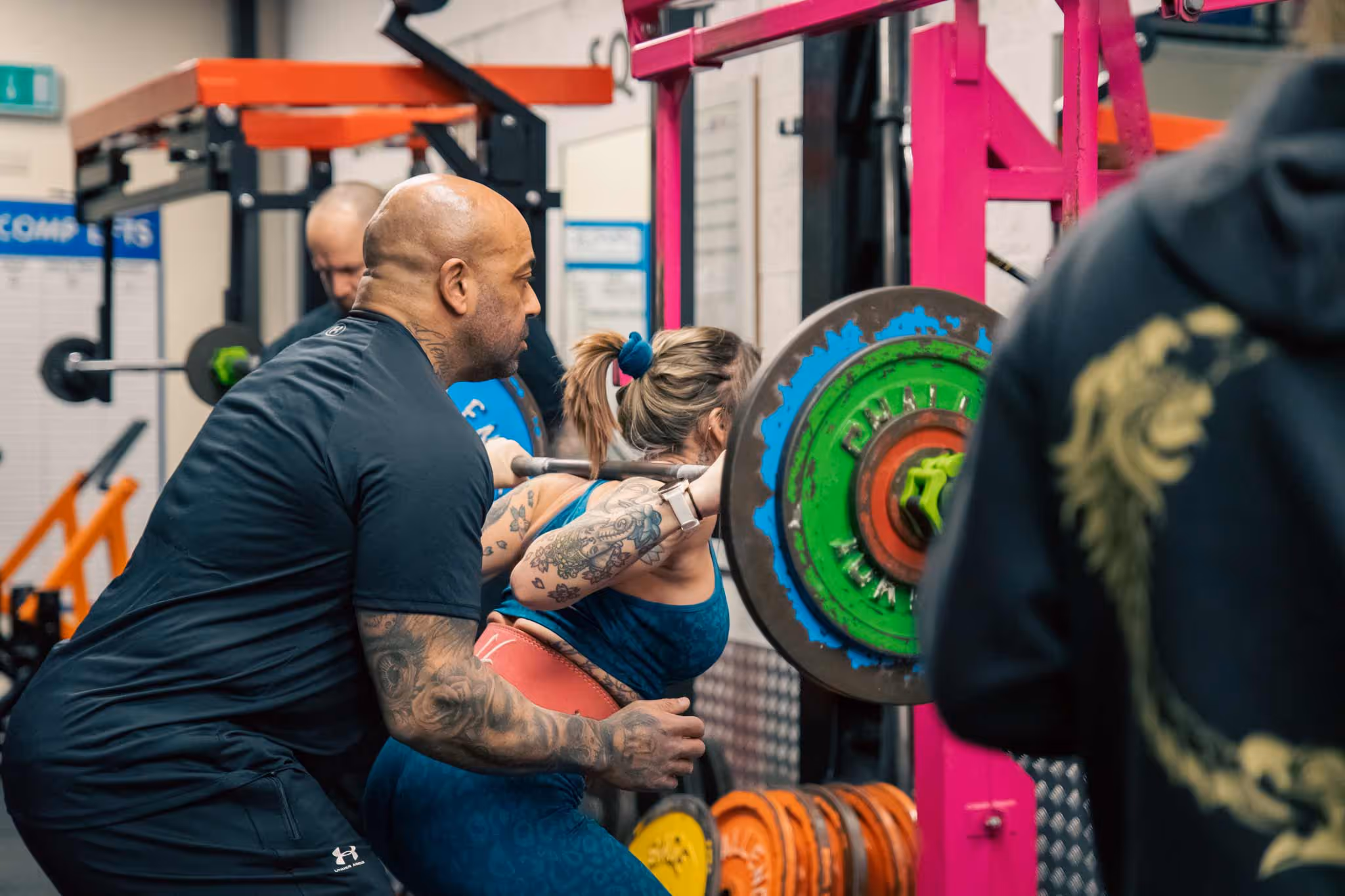 Man helping a woman exercise