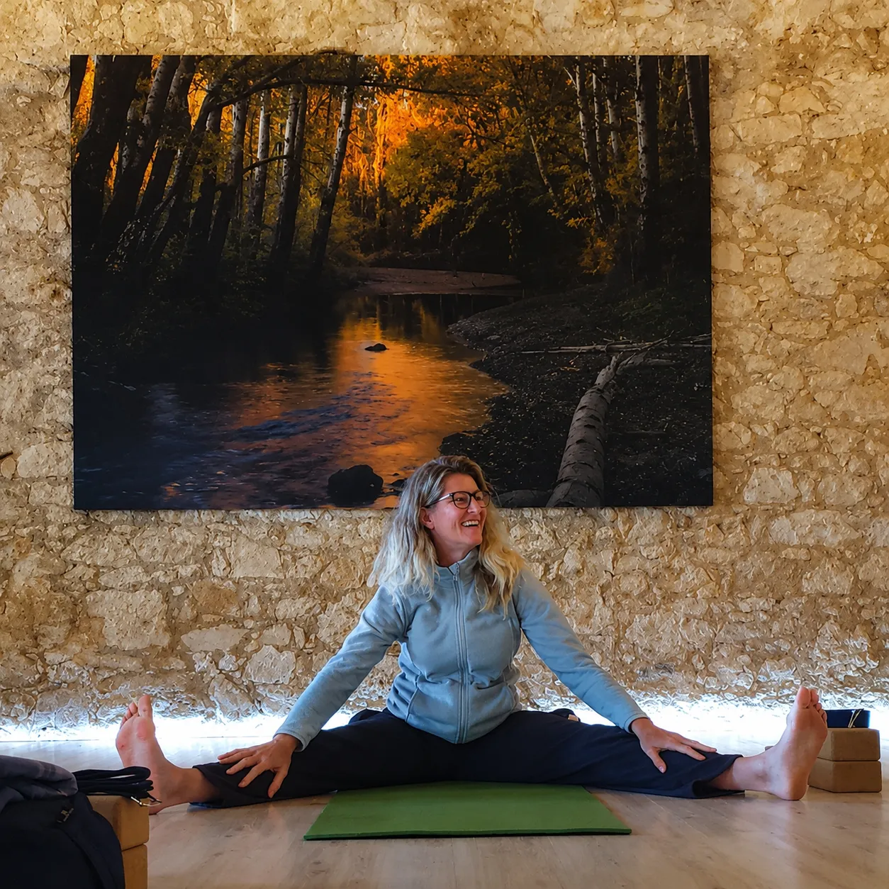 Eva leading a movement class in a beatiful classroom with a painting on the wall of a forest