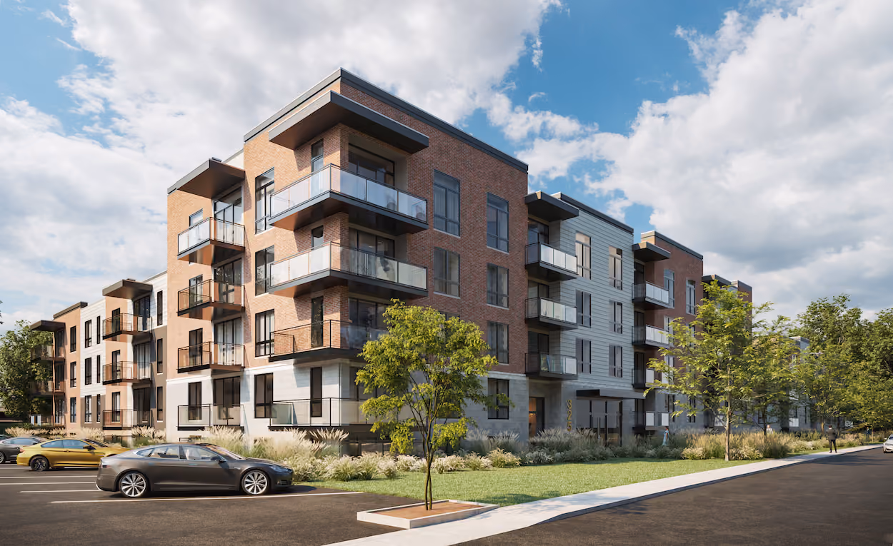 Modern four-story apartment building with balconies, trees, cars in parking lot, and partly cloudy sky.