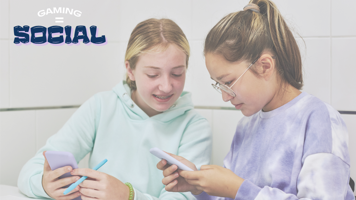 Two girls playing on mobile phones