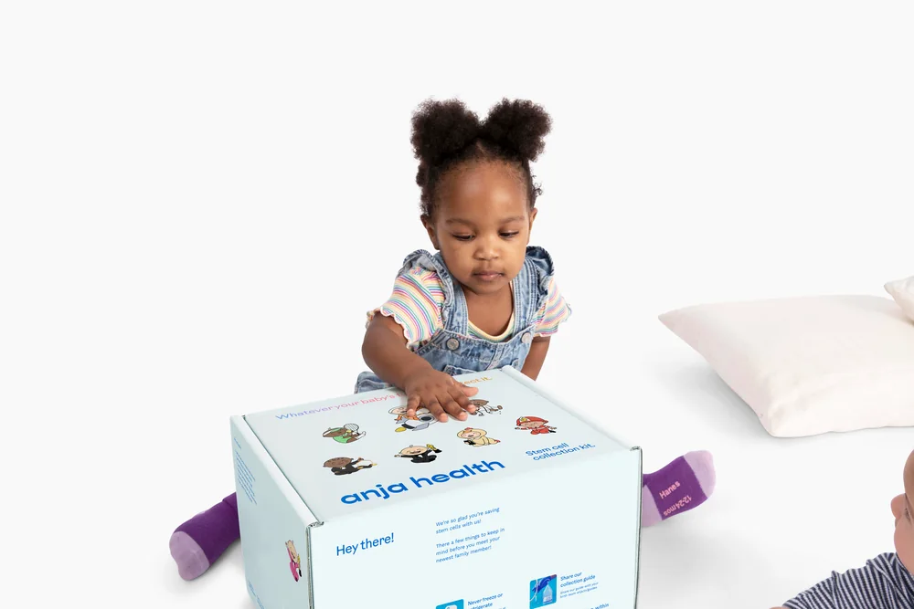 Toddler exploring an Anja Health collection kit box