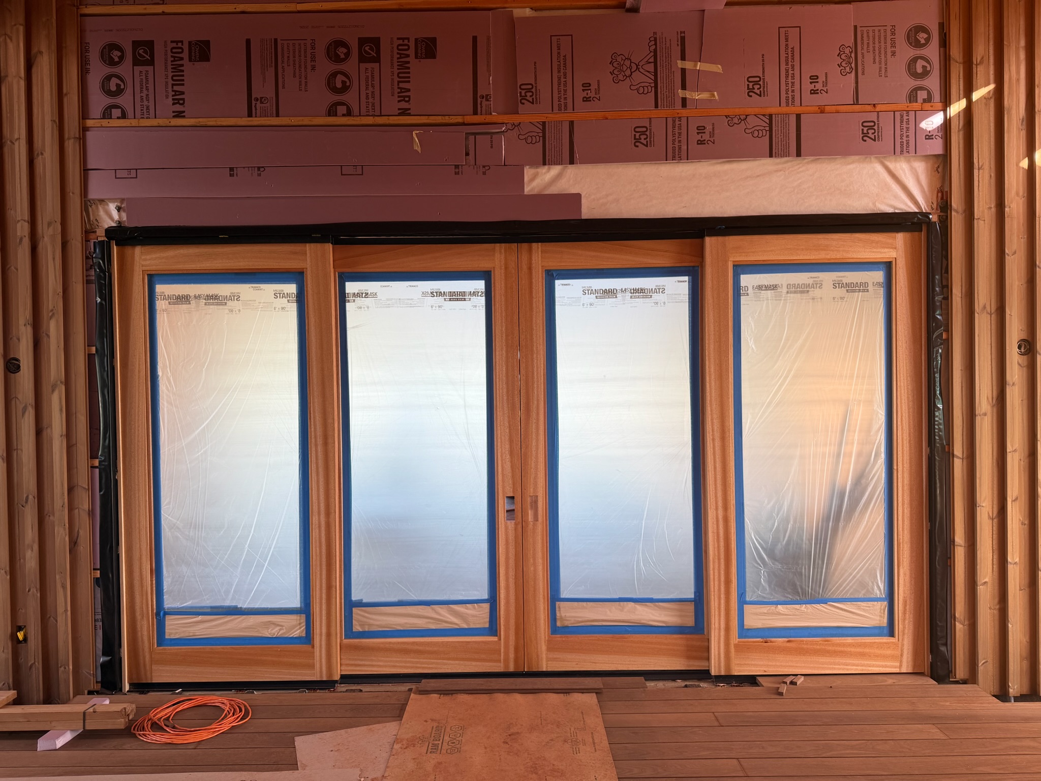 Albizia bifold doors being installed