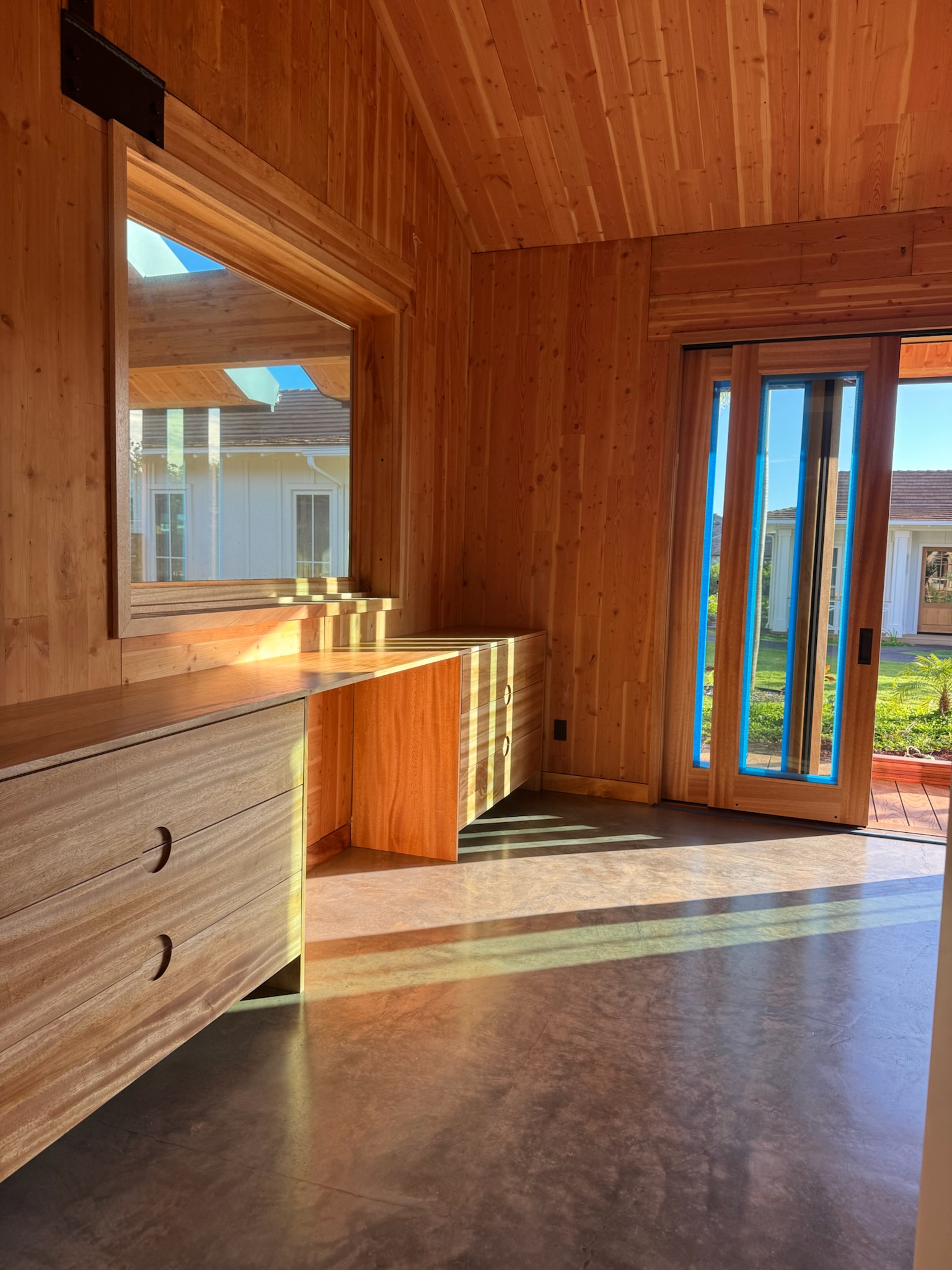 Wood-paneled bedroom with built-in vanity