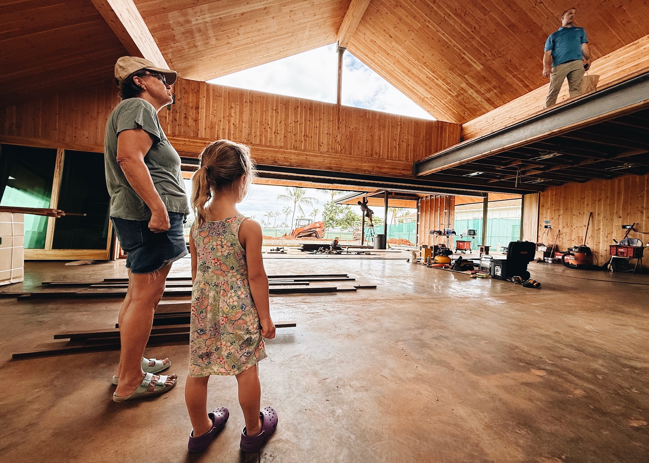 Family looking up at the roof structure on site