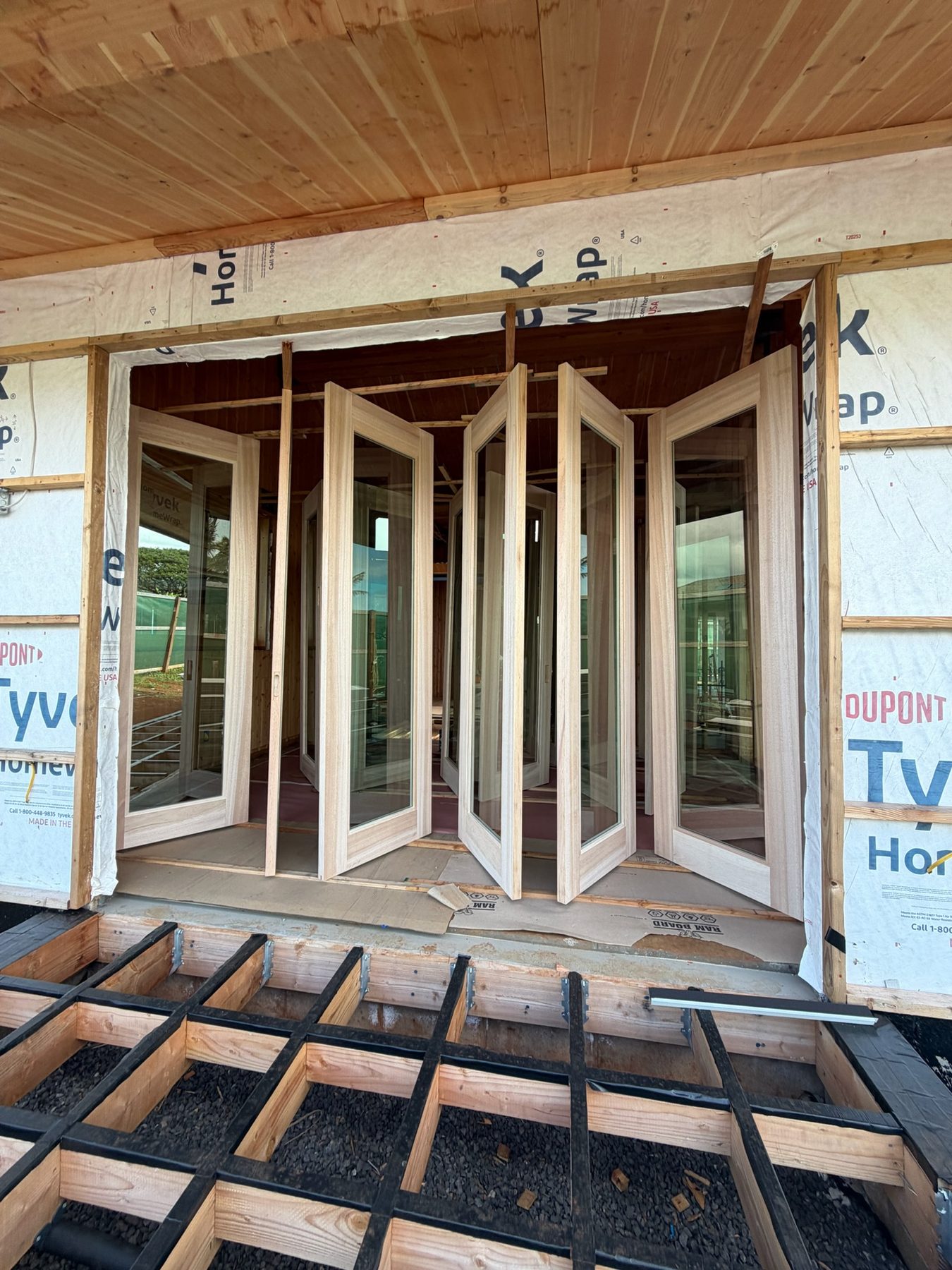 Albizia bifold doors being installed