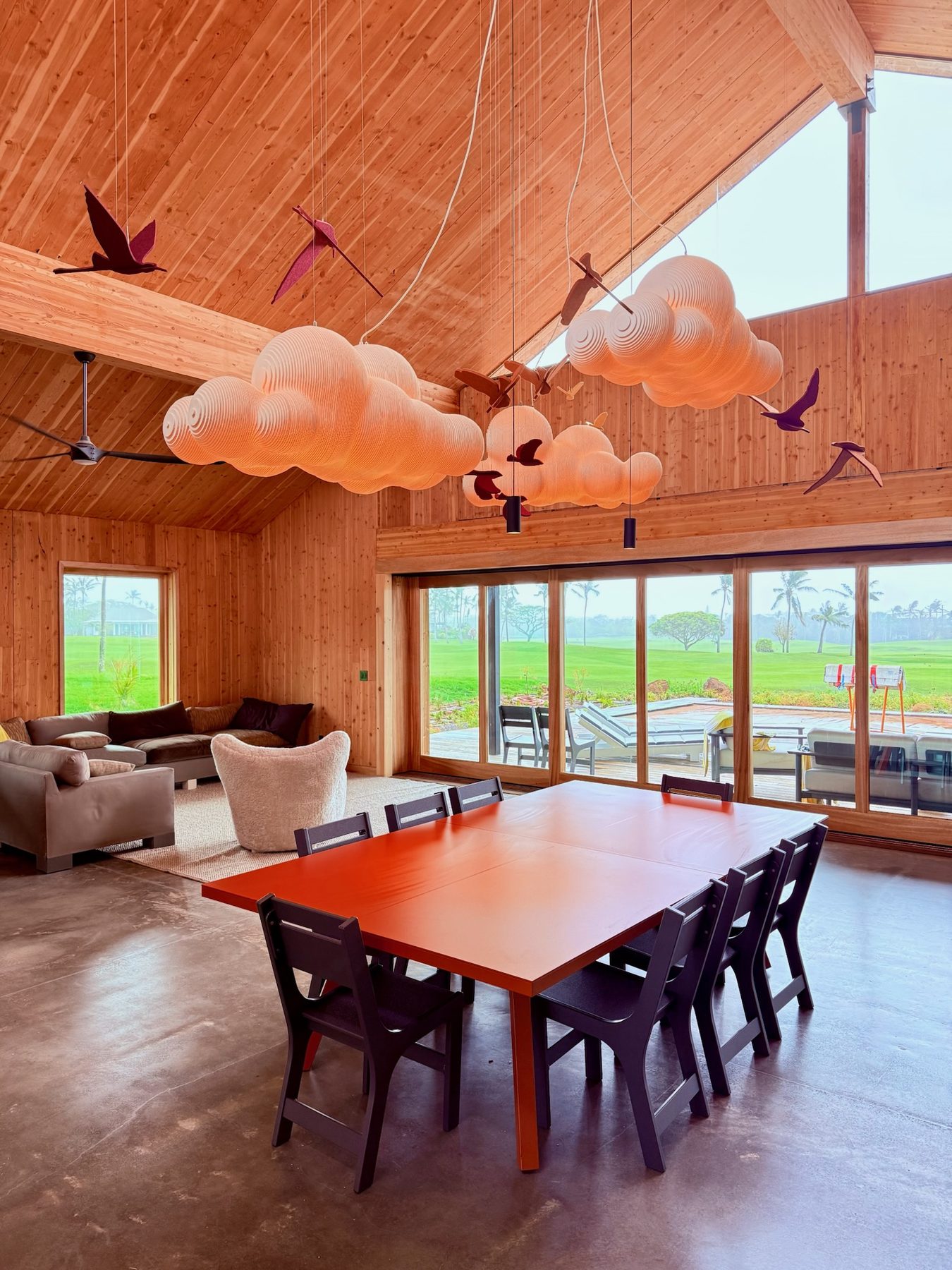 Great room with cloud pendant lights over the dining table
