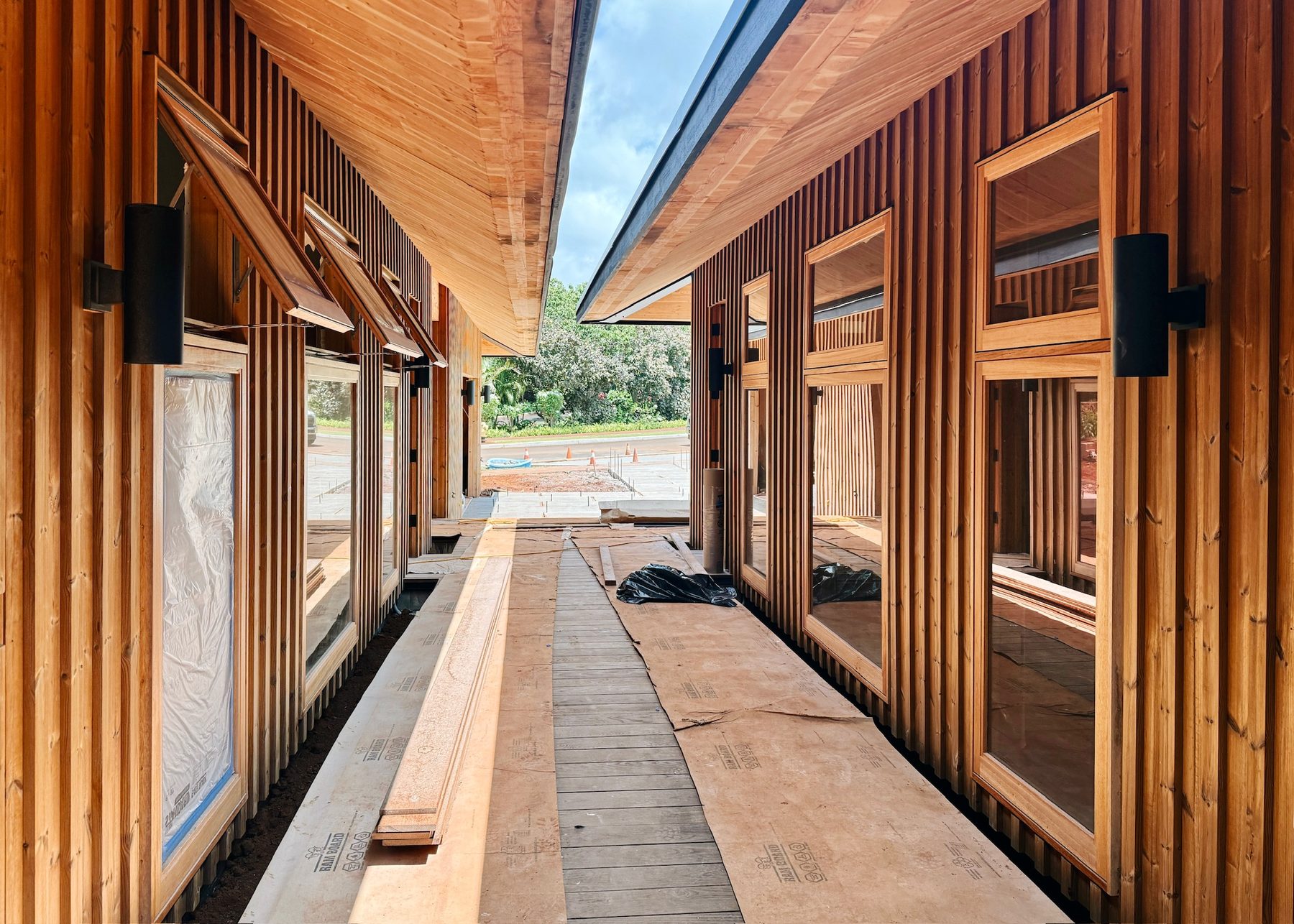 Wood siding and albizia-framed windows along the breezeway