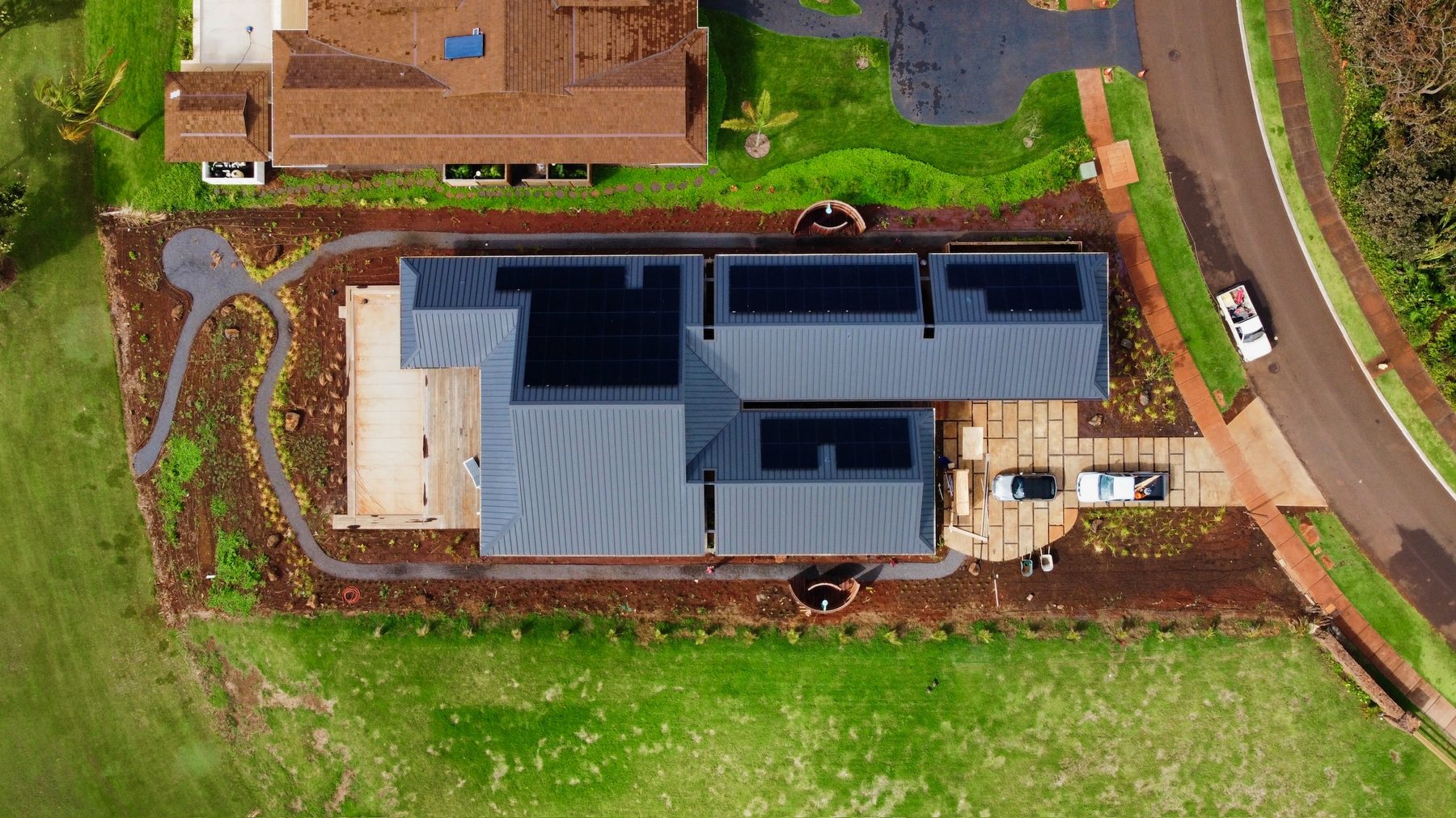 Aerial view of the finished home with solar panels