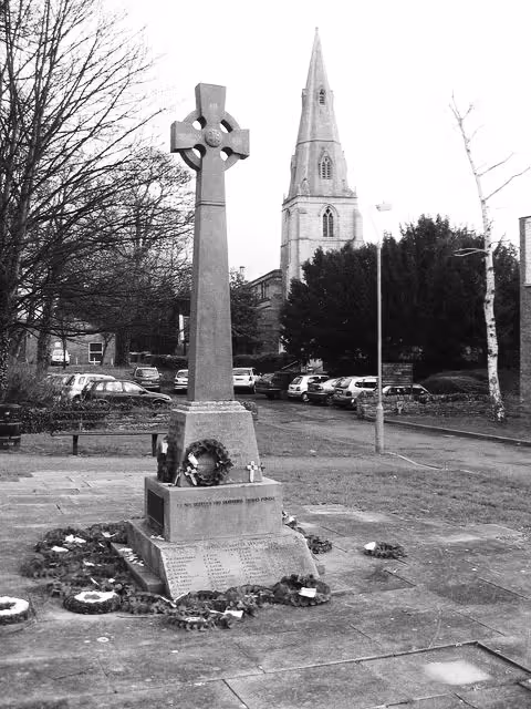 A black and white photo of a war memorial in Coalville, England.