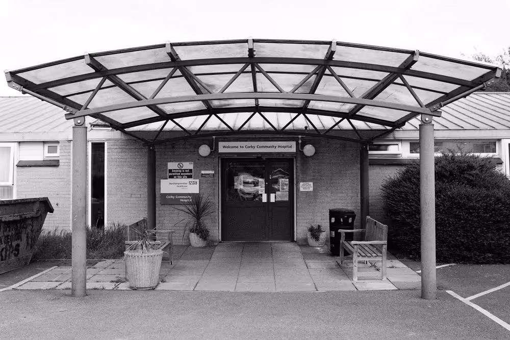 A black and white photo of Corby Community Hospital.