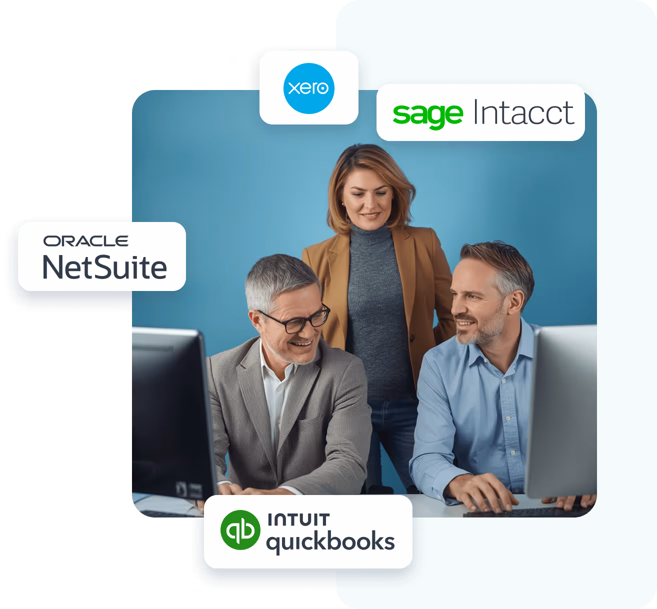 Three business professionals, two men seated at computers and a woman standing behind them, all smiling and collaborating in an office with a blue wall.