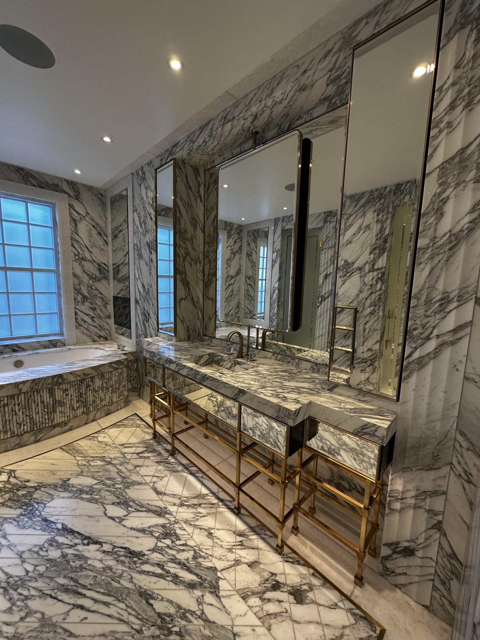 A renovated master bathroom with high finishings and marble