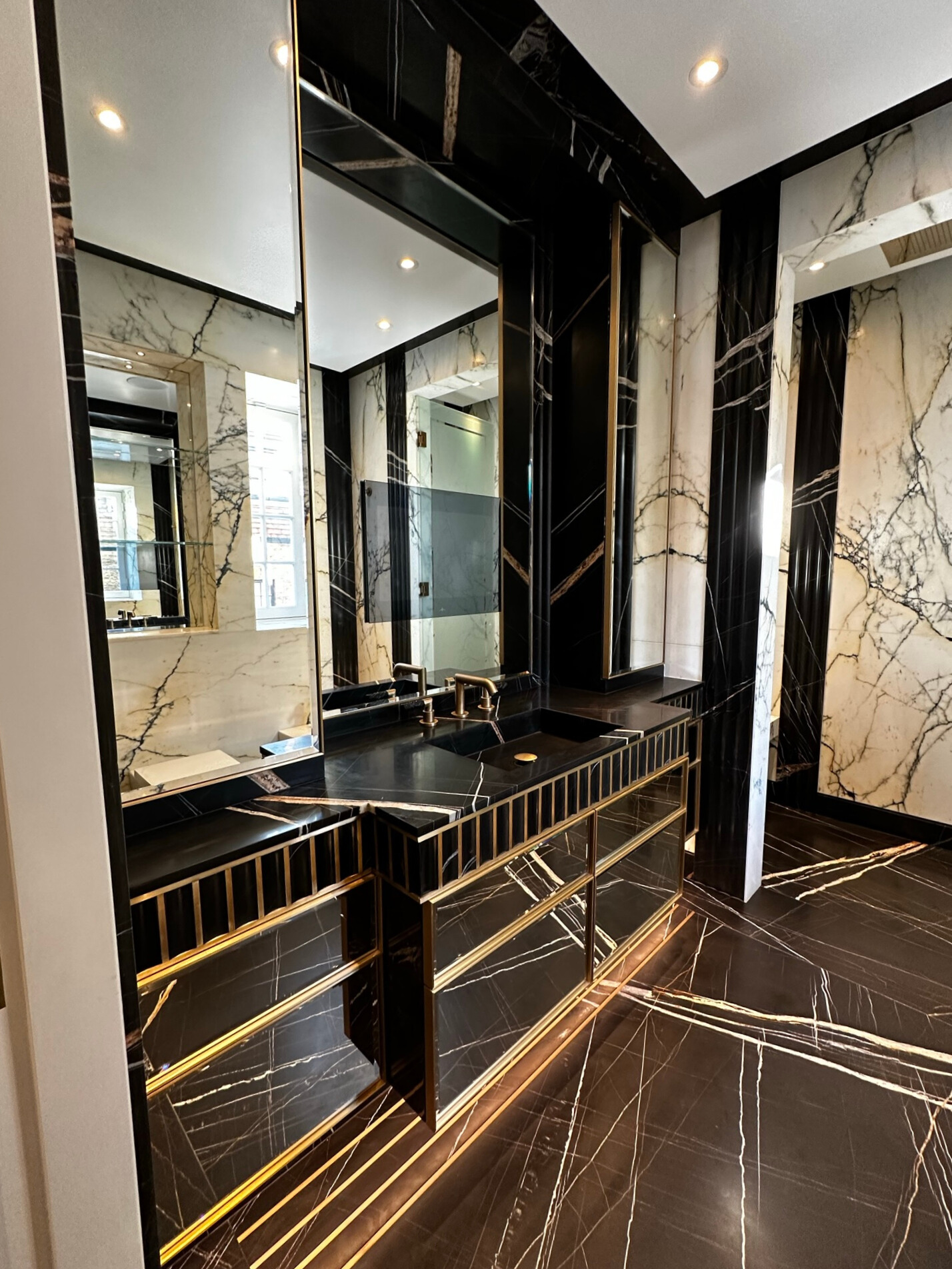 A luxurious bathroom at Amberwood House featuring black and gold marble