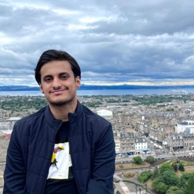 a man standing on top of a building with a city in the background