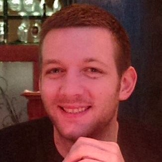 a man smiling with his hand on his chin